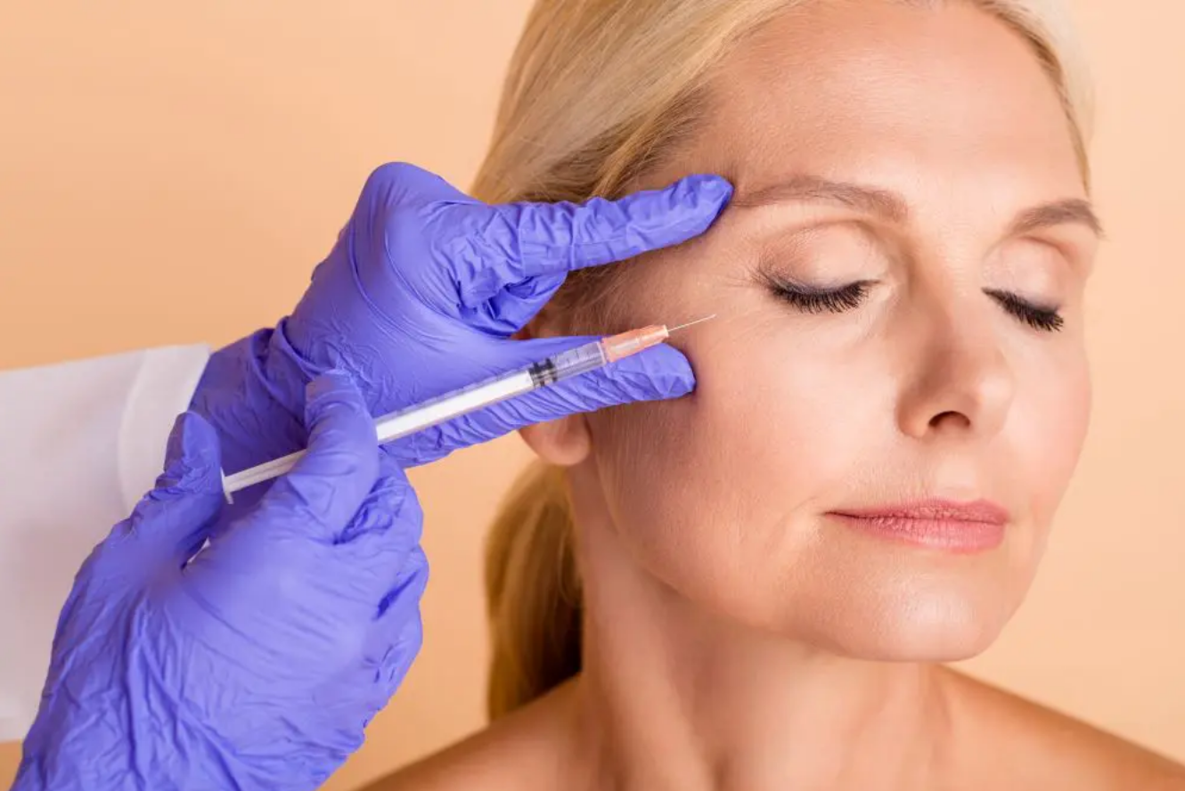 Woman receiving Botox injections to smooth forehead wrinkles at a professional medspa in Chantilly, VA.