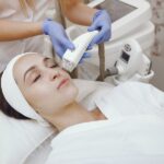A woman receiving a HydraFacial treatment at a professional medspa in Chantilly,