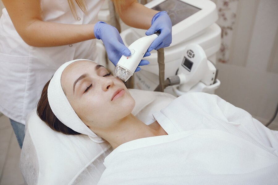 A woman receiving a HydraFacial treatment at a professional medspa in Chantilly,